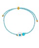 Χειροποίητο βραχιόλι της Excite Fashion Jewellery, δίχρωμο κορδόνι, λευκό ματάκι κύβος, τιρκουάζ χάντρα, και χρυσές μπίλιες. B-1774-17 Κοσμήματα