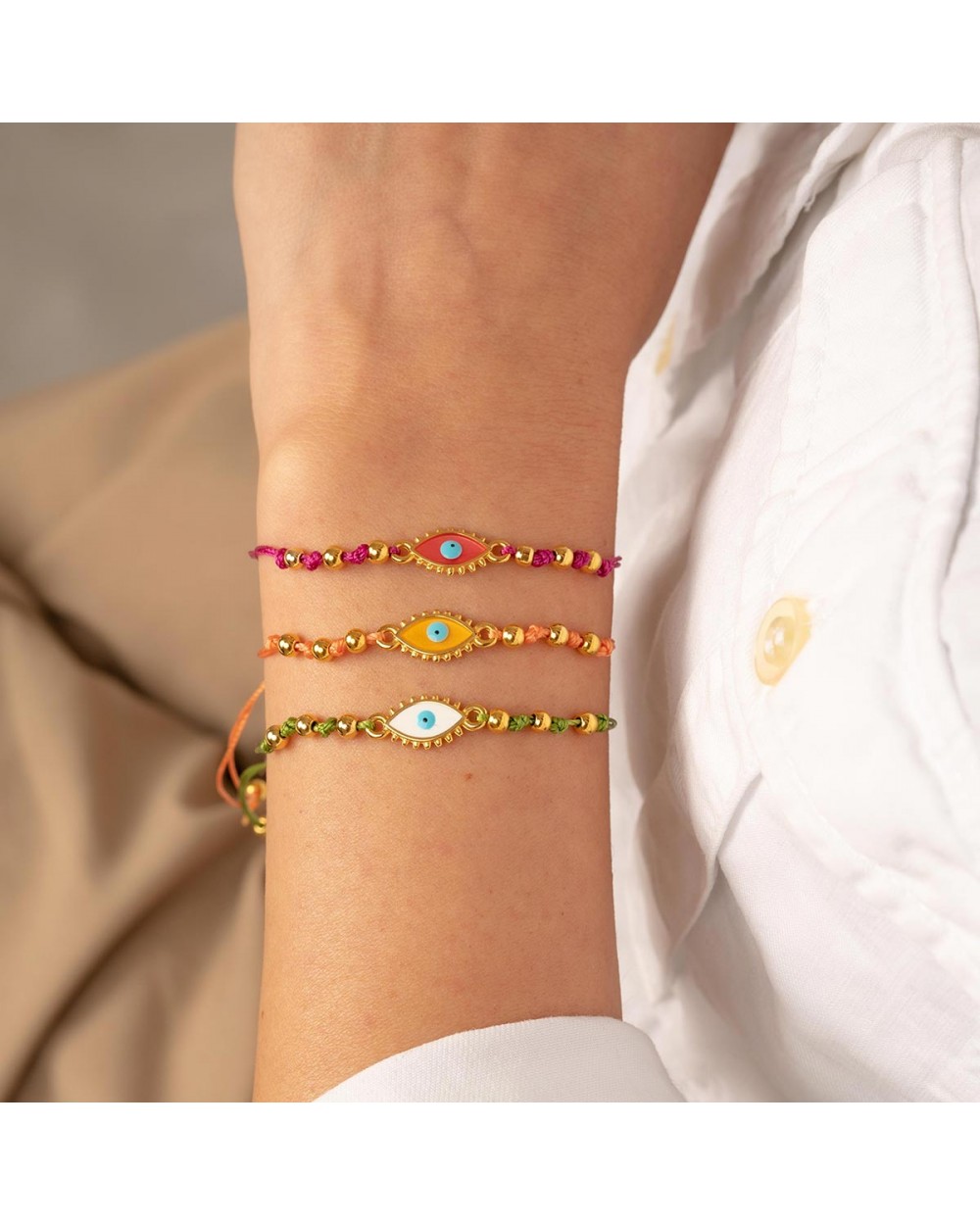 Χειροποίητο βραχιόλι μακραμέ της Excite Fashion Jewellery, πορτοκαλί κορδόνι, οβάλ επίχρυσο ματάκι με  σμάλτο, και χρυσές μπίλιες. B-1784-22 Κοσμήματα